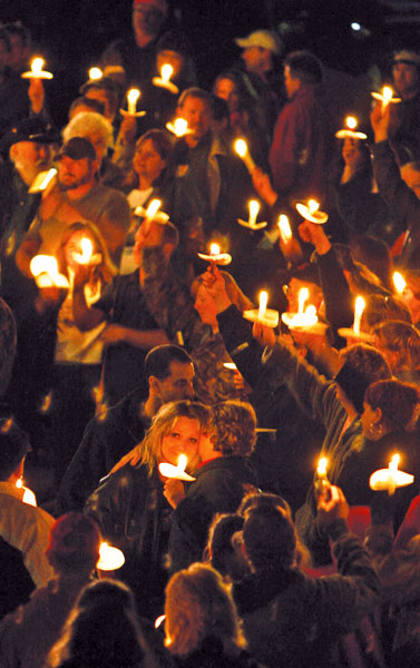 Area residents attempt to burn through their votive candle supply in an attempt to escape the vigil.